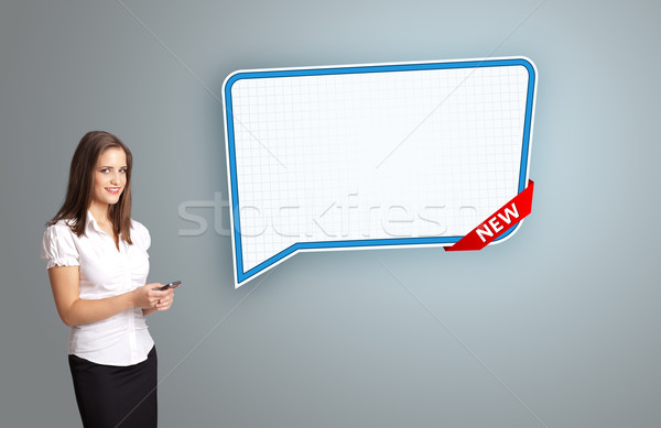 beautiful young woman holding a phone and presenting modern speech bubble copy space Stock photo © ra2studio