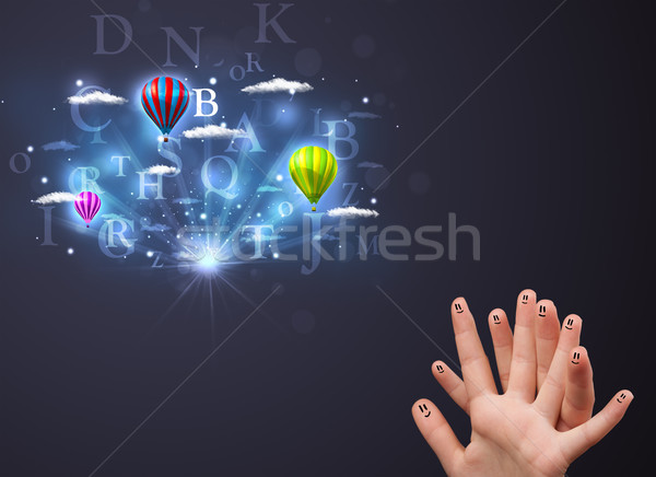 Happy cheerful smiley fingers looking at hot air balloons in the cloudy sky Stock photo © ra2studio
