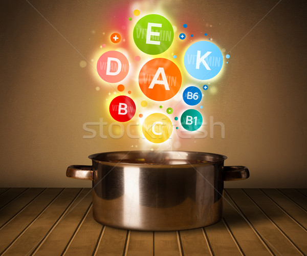 Colorful vitamins coming out from cooking pot Stock photo © ra2studio