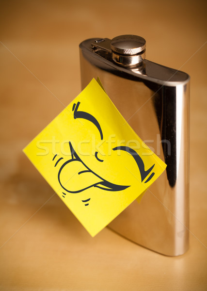Post-it note with smiley face sticked on hip flask Stock photo © ra2studio