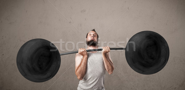 Funny skinny guy lifting weights Stock photo © ra2studio