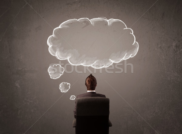 Businessman sitting with cloud thought above his head Stock photo © ra2studio