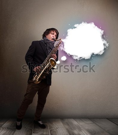 Young man playing on saxophone with copy space in white cloud Stock photo © ra2studio