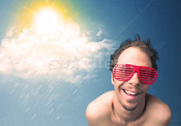 Stock photo: Young person looking with sunglasses at clouds and sun