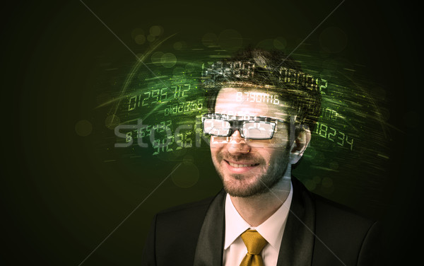 Stock photo: Business man looking at high tech number calculations 