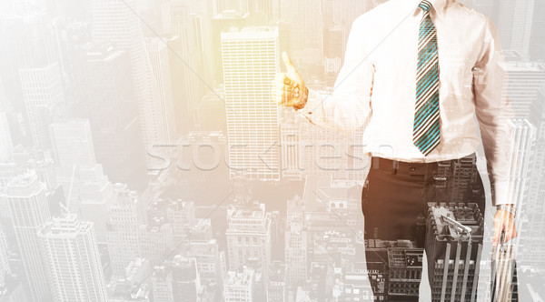 Business person with warm color overlay of city background Stock photo © ra2studio