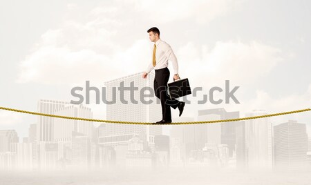 Empresário equilíbrio dourado corda jovem elegante Foto stock © ra2studio