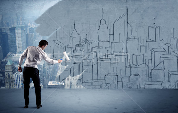 Elegant salesman repainting the city on wall Stock photo © ra2studio