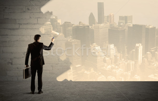 Salesman painting city scape on wall Stock photo © ra2studio