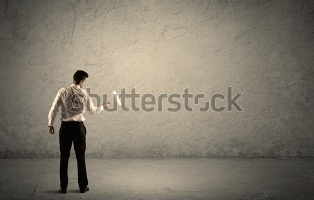 Salesman with roller standing at empty wall Stock photo © ra2studio