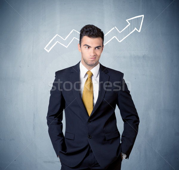 Smiling business guy with graph arrow Stock photo © ra2studio