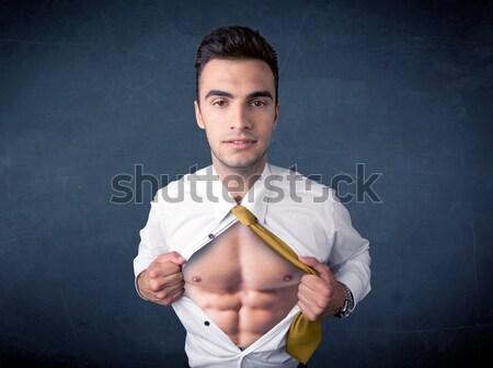 Stock photo: Businessman tearing off shirt and showing mucular body