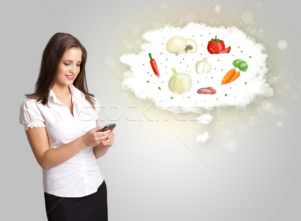 Pretty woman presenting a cloud of healthy nutritional vegetable Stock photo © ra2studio