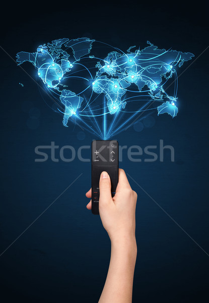 Hand with remote control, social media concept Stock photo © ra2studio