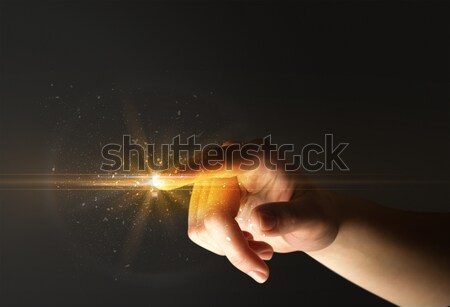 Hand with remote control and shining numbers Stock photo © ra2studio