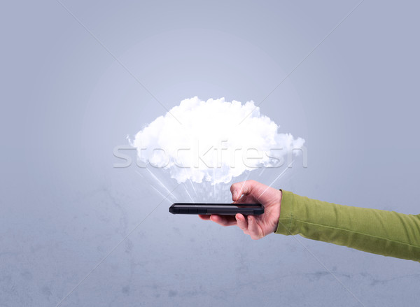 Hand holding phone with empty cloud Stock photo © ra2studio