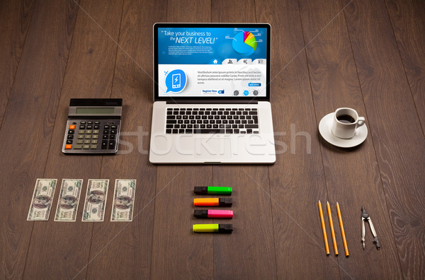 Laptop on office desk with business website on screen Stock photo © ra2studio