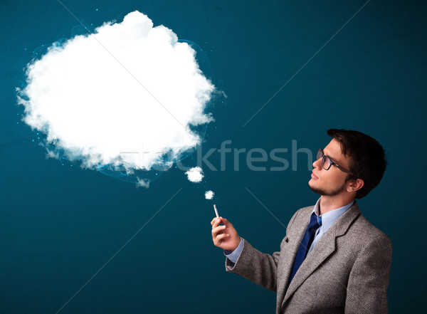 Young man smoking unhealthy cigarette with dense smoke Stock photo © ra2studio