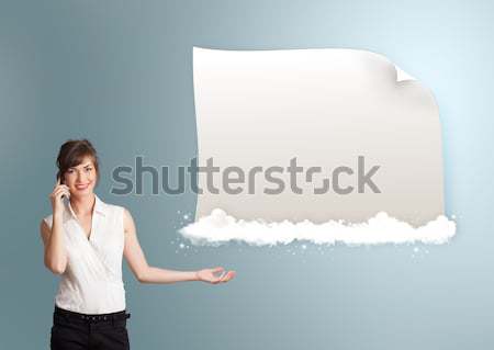 Stock photo: pretty young woman making phone call and presenting modern copy space on clouds