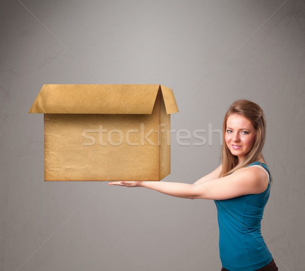 Young woman holding an empty cardboard box Stock photo © ra2studio