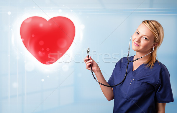 Młodych pielęgniarki uzdrowienie czerwony serca dość Zdjęcia stock © ra2studio