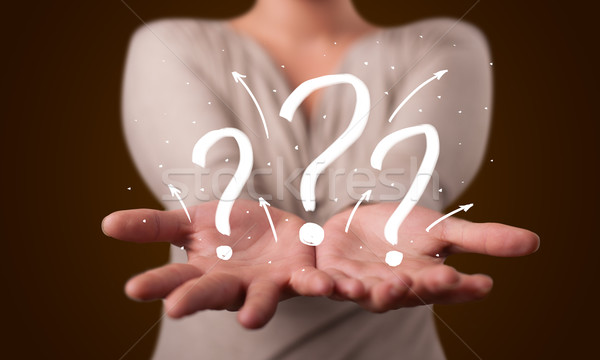 Young woman presenting hand drawn question marks Stock photo © ra2studio