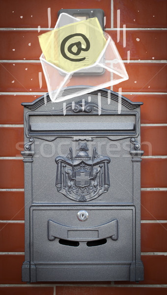 Stock photo: Envelope with email sign dropping into mailbox