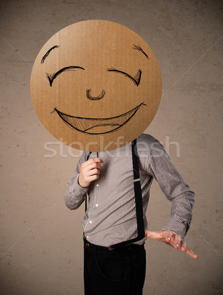 üzletember tart mosolygós arc tábla karton emotikon Stock fotó © ra2studio