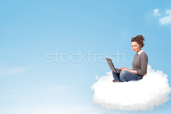 Young woman with laptop sitting on cloud with copy space Stock photo © ra2studio