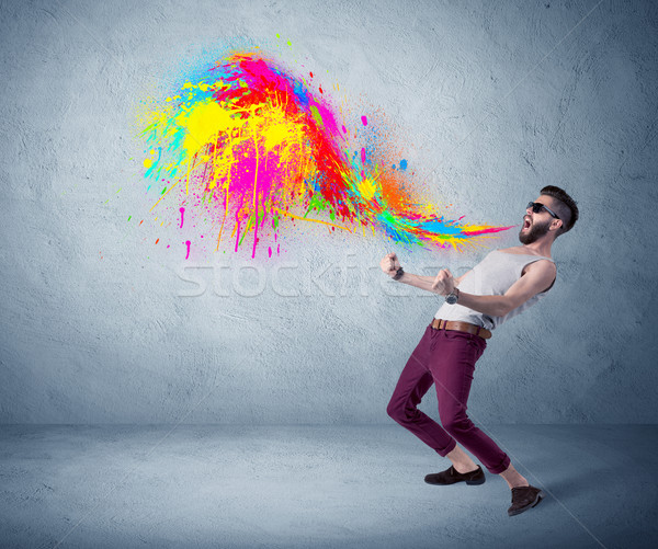 Hipster guy shouting colorful paint on wall Stock photo © ra2studio