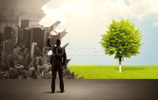 Salesman painting tree instead of city Stock photo © ra2studio