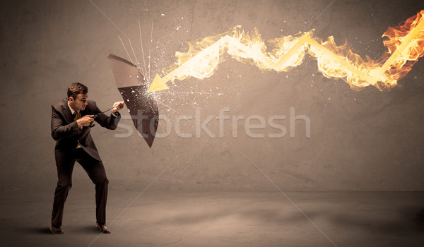 Uomo d'affari fuoco arrow ombrello pioggia Foto d'archivio © ra2studio