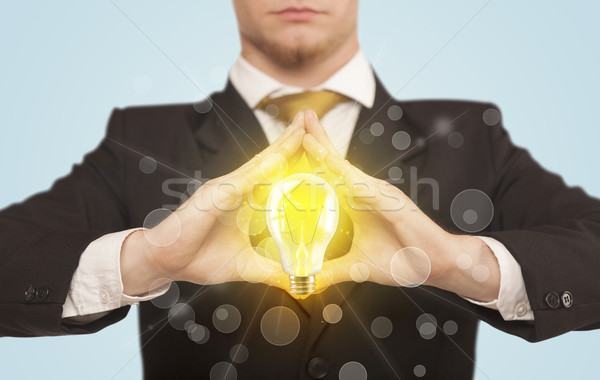 Hands creating a form with light bulb Stock photo © ra2studio