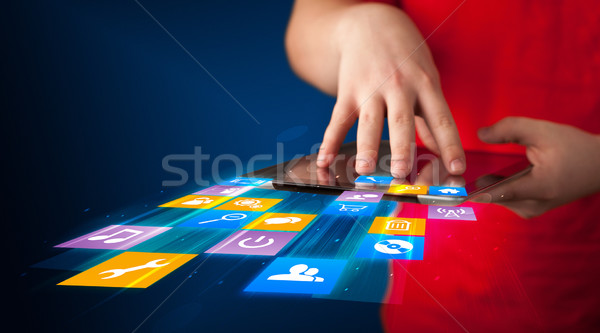 Stock photo: Hand holding tablet device with media application