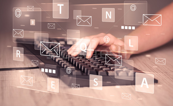 Hand typing on keyboard with digital tech icons Stock photo © ra2studio