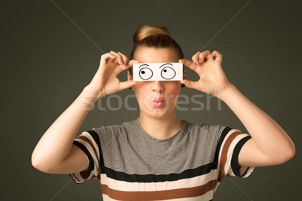 Stock photo: Young silly girl looking with hand drawn eye balls on paper