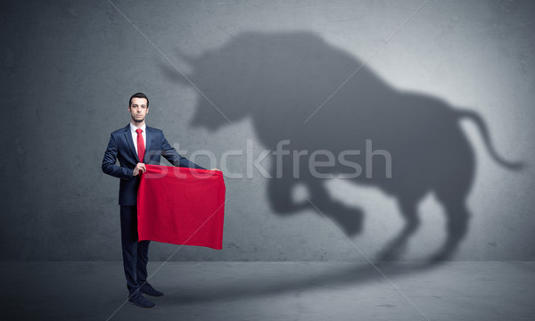 Businessman with bull shadow and toreador concept Stock photo © ra2studio
