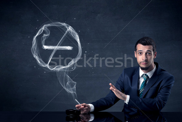 Businessman smoking cigarette. Stock photo © ra2studio