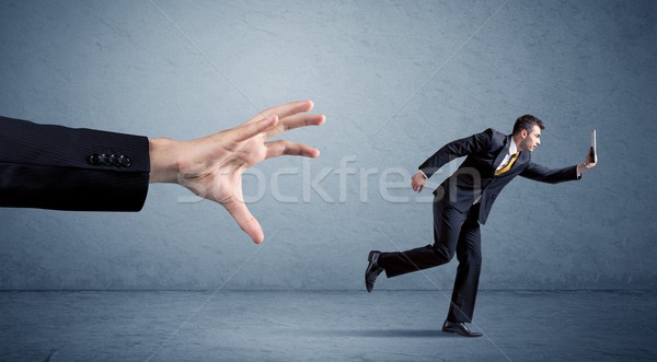 Businessman running from hand Stock photo © ra2studio