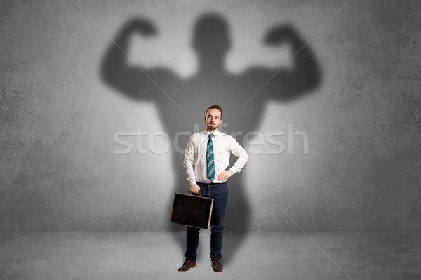 Businessman with muscular shade behind his back Stock photo © ra2studio