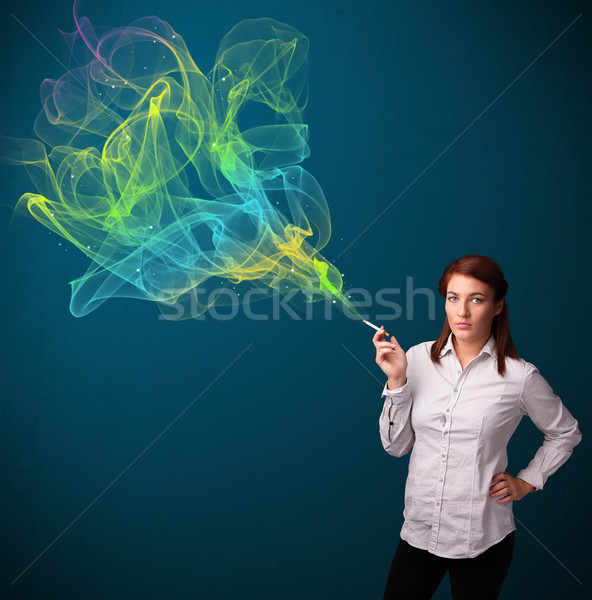 Pretty lady smoking cigarette with colorful smoke Stock photo © ra2studio