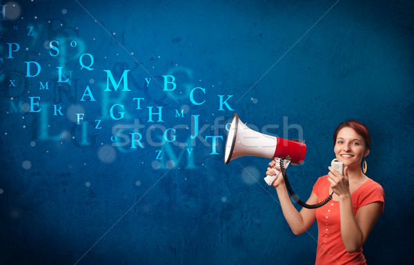 Young girl shouting into megaphone and text come out Stock photo © ra2studio
