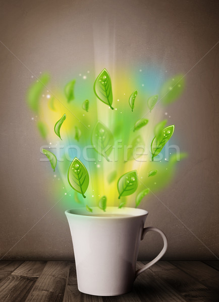 Stock photo: Tea cup with leaves and colorful abstract lights