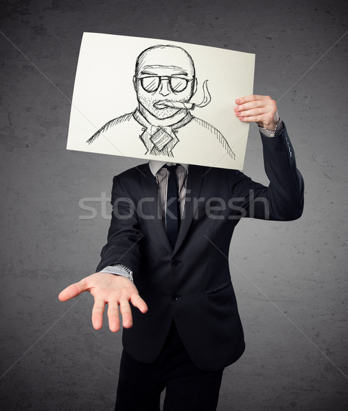 Businessman holding a cardboard with a smoking man on it in fron Stock photo © ra2studio