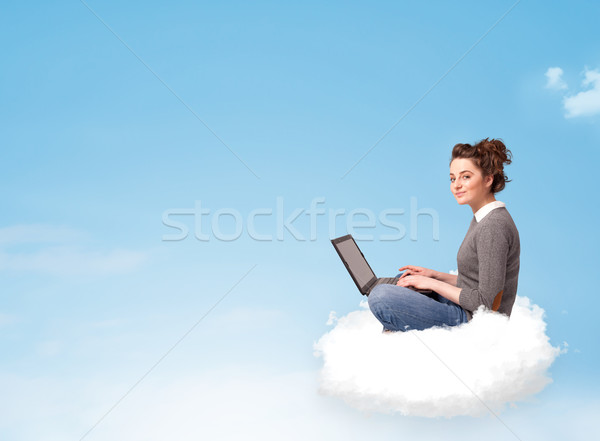 Young woman with laptop sitting on cloud with copy space Stock photo © ra2studio