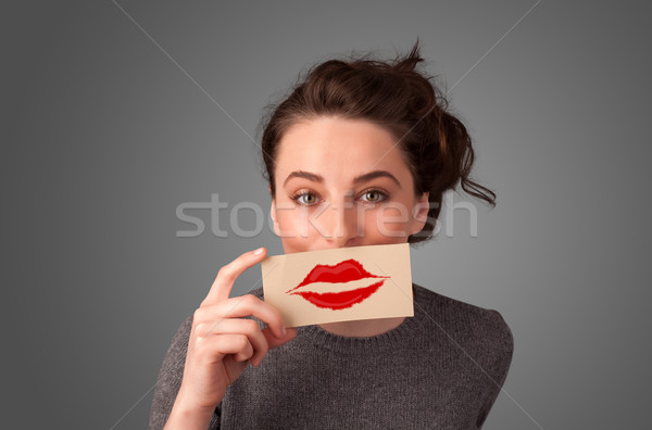 Stock photo: Happy pretty woman holding card with kiss lipstick mark