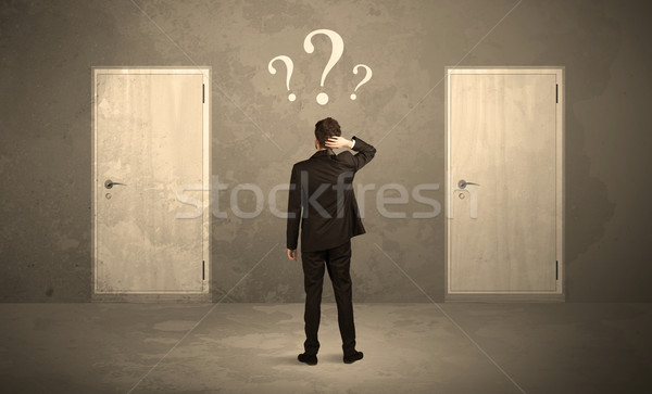 Businessman standing in front of doors Stock photo © ra2studio