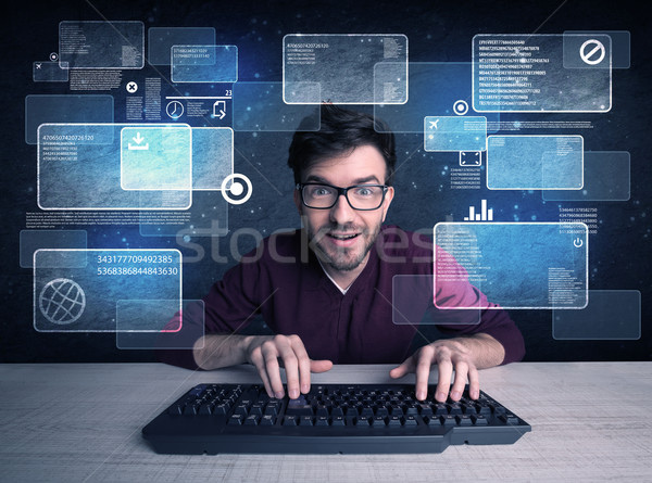 Nerd with glasses hacking websites Stock photo © ra2studio