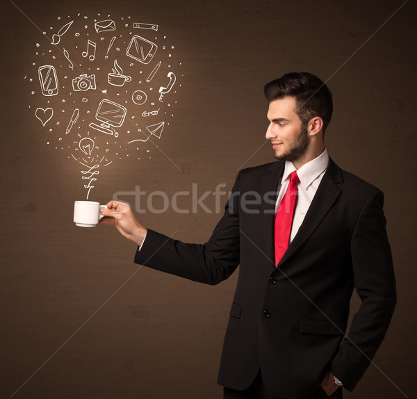 Businessman holding a white cup with social media icons Stock photo © ra2studio