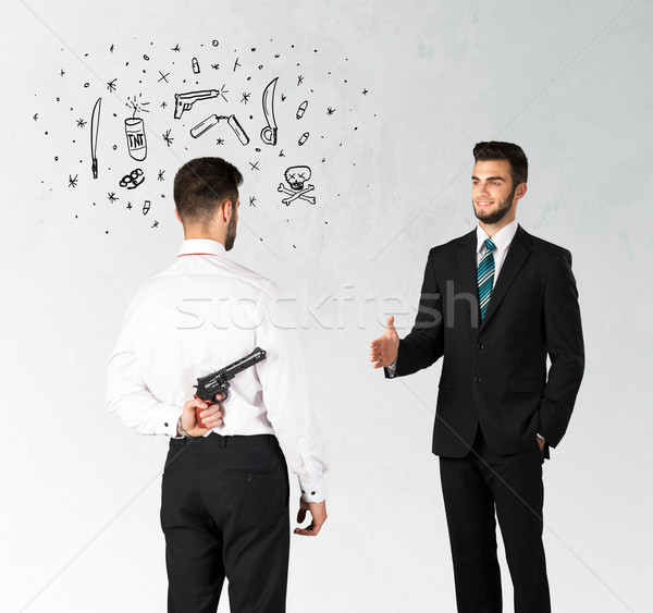Afaceri om de afaceri strângere de mână ascunzatoare armă simboluri Imagine de stoc © ra2studio